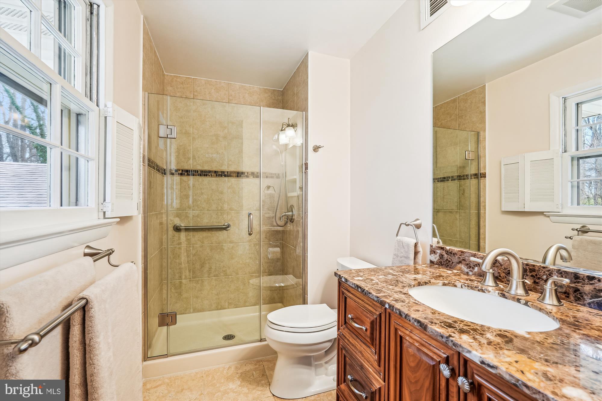 16523 Kipling Road Rockville, MD 20855 - Photo 21 of 50 a bathroom with a granite countertop sink toilet and shower