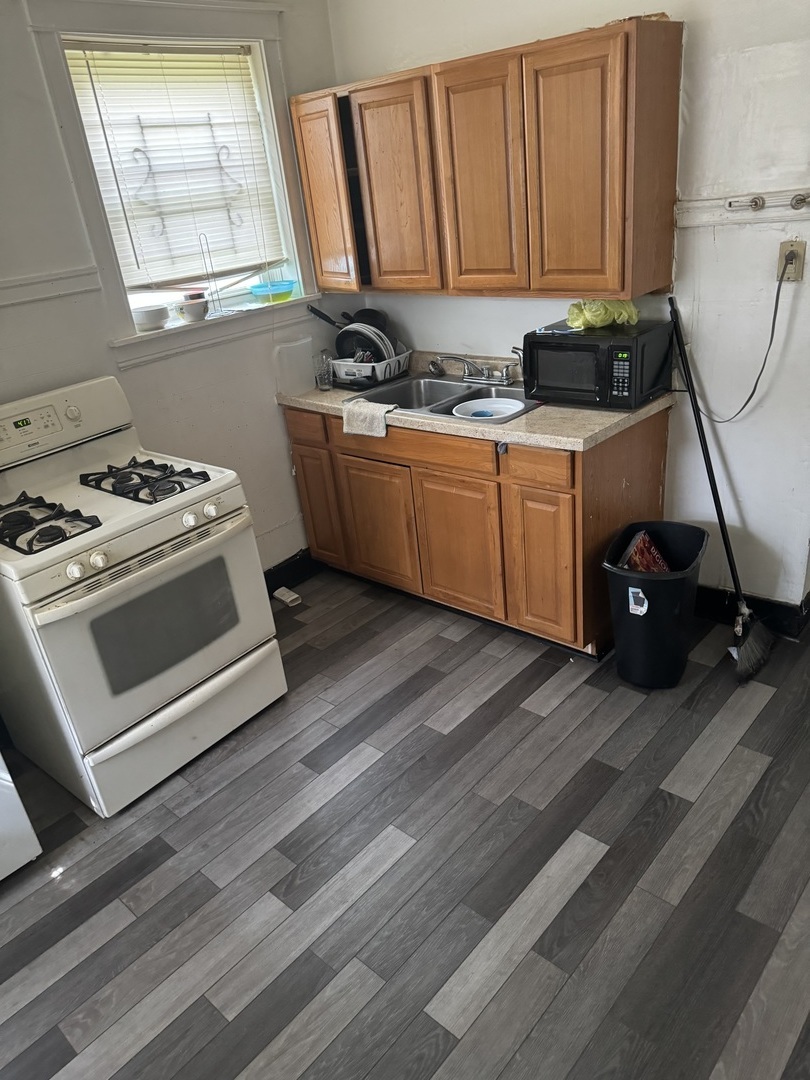 5758 South Honore Street Chicago, IL 60636 - Photo 11 of 57 a kitchen with stainless steel appliances a stove a sink and a cabinets