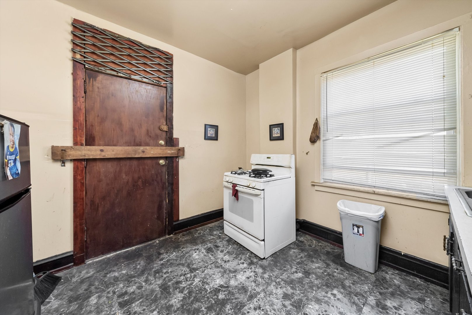5758 South Honore Street Chicago, IL 60636 - Photo 13 of 57 a room with a stove and a washer dryer