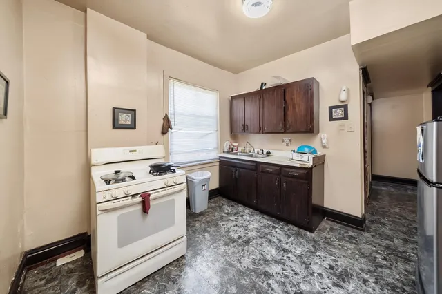 a kitchen with stainless steel appliances a stove a sink and a refrigerator