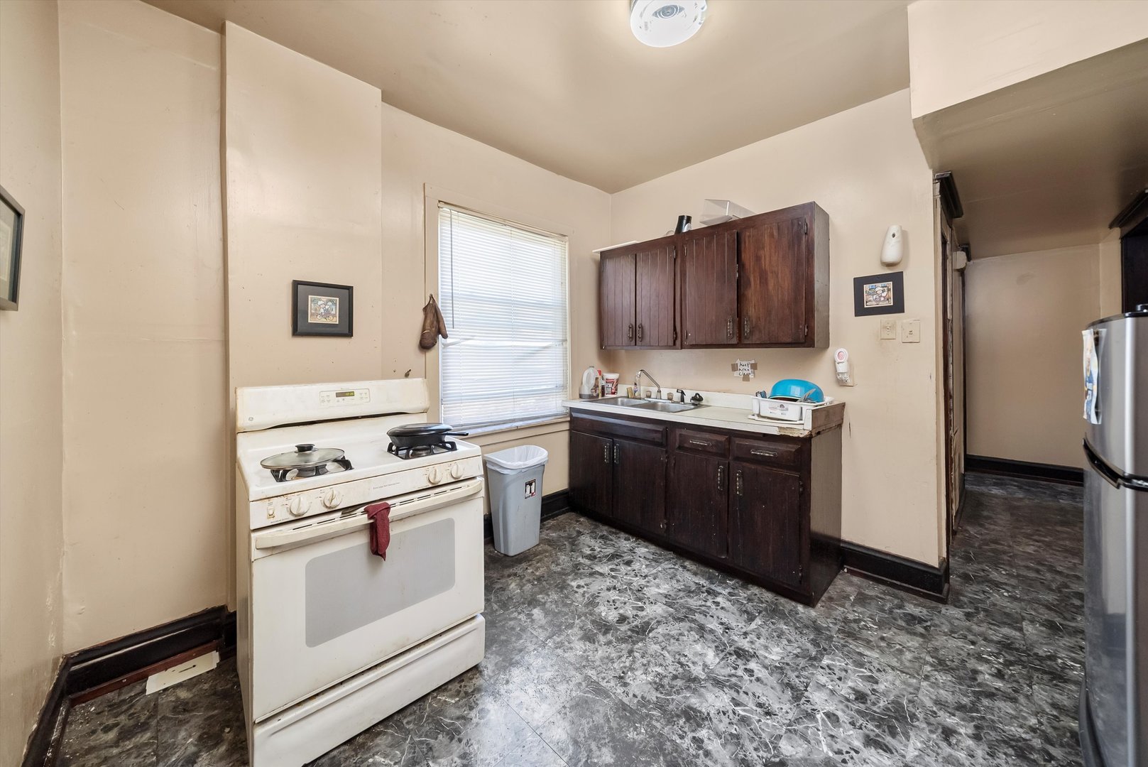 5758 South Honore Street Chicago, IL 60636 - Photo 14 of 57 a kitchen with stainless steel appliances a stove a sink and a refrigerator