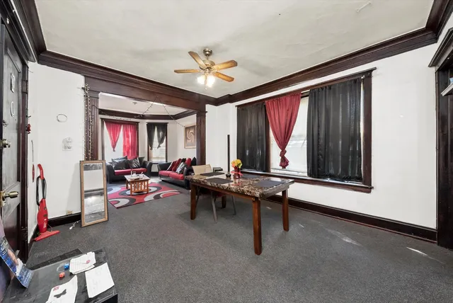 a living room with furniture a window and a flat screen tv