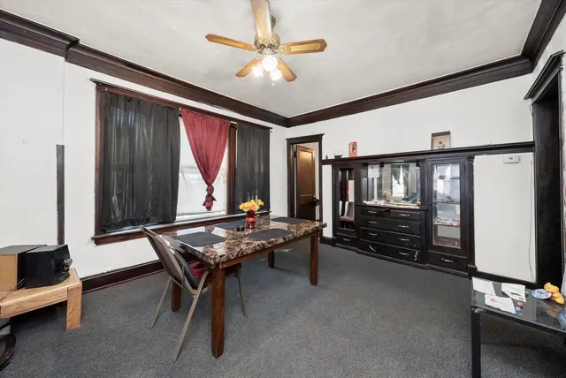a living room with furniture a air conditioner and a window