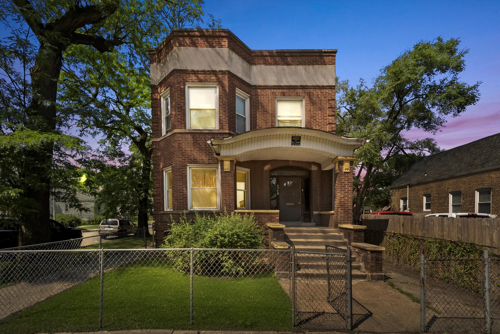 5758 South Honore Street Chicago, IL 60636 - Photo 2 of 57 a front view of a house with a garden