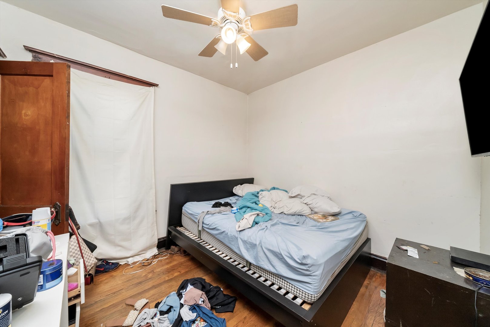 5758 South Honore Street Chicago, IL 60636 - Photo 31 of 57 a bed sitting in a bedroom next to a window