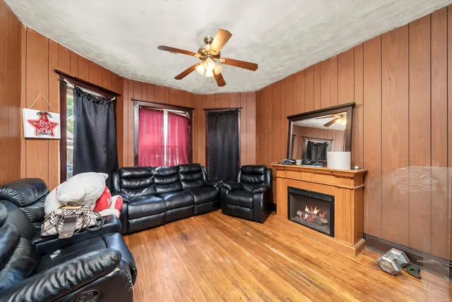 a dining room with furniture a chandelier and wooden floor