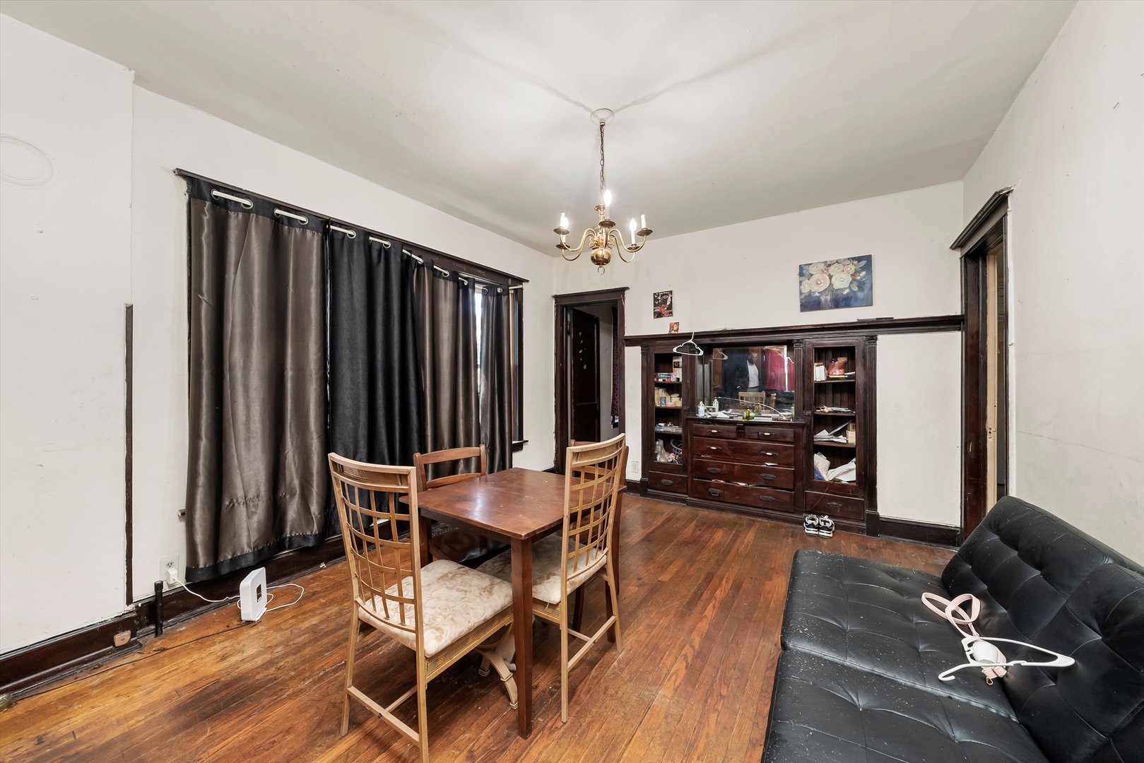 5758 South Honore Street Chicago, IL 60636 - Photo 38 of 57 a dining room with furniture a chandelier and wooden floor
