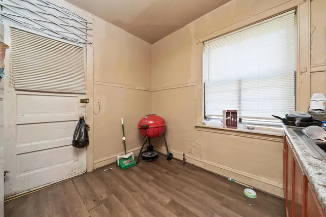a kitchen with granite countertop a sink cabinets and wooden floor