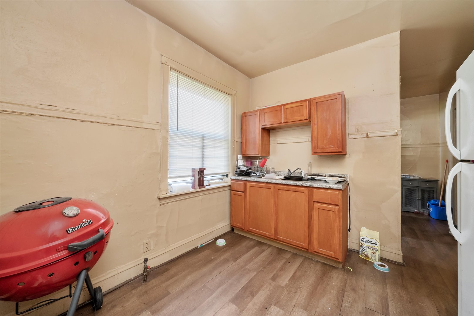 5758 South Honore Street Chicago, IL 60636 - Photo 41 of 57 a kitchen with granite countertop a sink cabinets and wooden floor