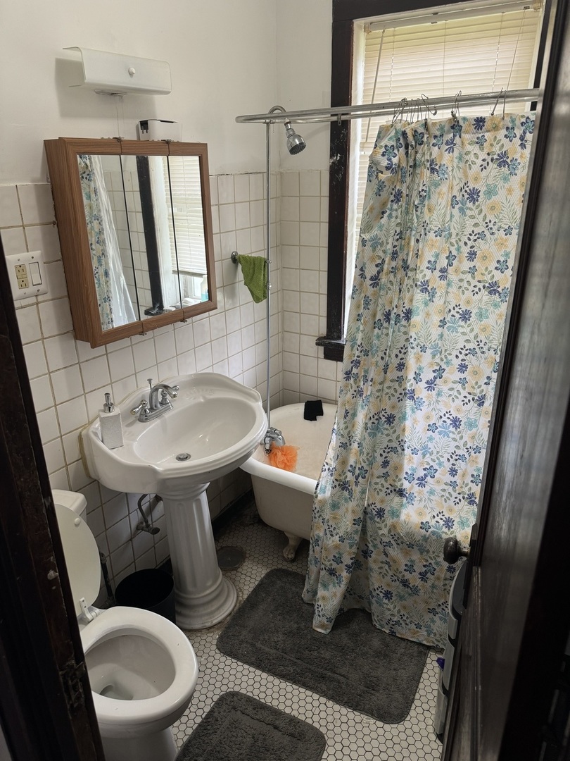 5758 South Honore Street Chicago, IL 60636 - Photo 9 of 57 a bathroom with a sink toilet and shower