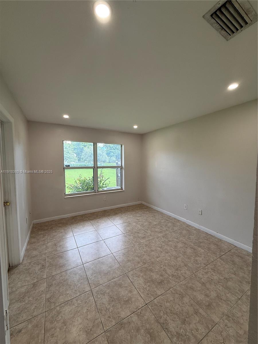 7612 Northwest 38th Court, Unit 13 Davie, FL 33024 - Photo 4 of 10 an empty room with windows