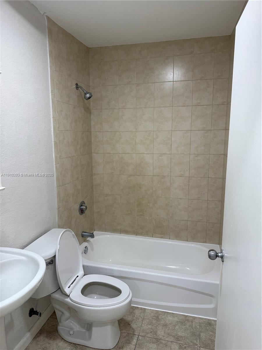 7612 Northwest 38th Court, Unit 13 Davie, FL 33024 - Photo 6 of 10 a bathroom with a toilet and a shower