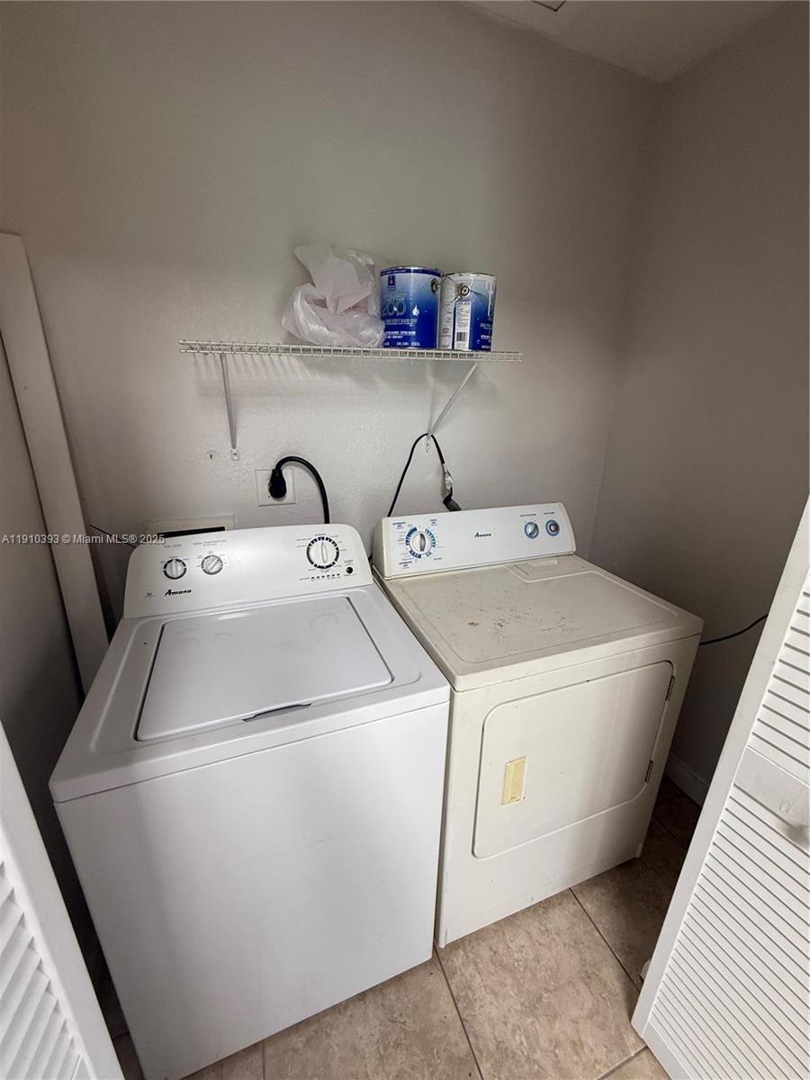 7612 Northwest 38th Court, Unit 13 Davie, FL 33024 - Photo 8 of 10 a utility room with dryer and washer