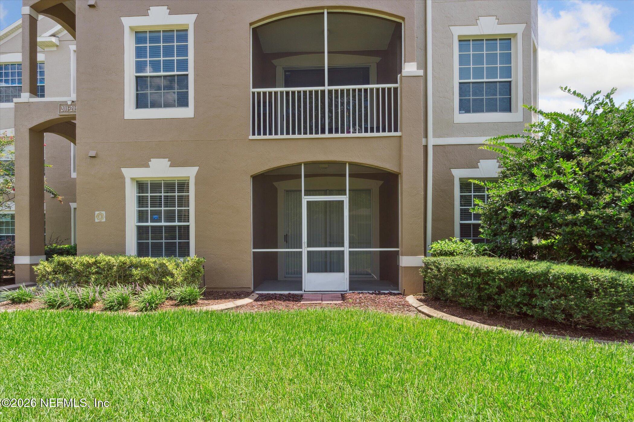 7990 Baymeadows Road, Unit 201 Jacksonville, FL 32256 - Photo 28 of 42 a front view of a house with a yard