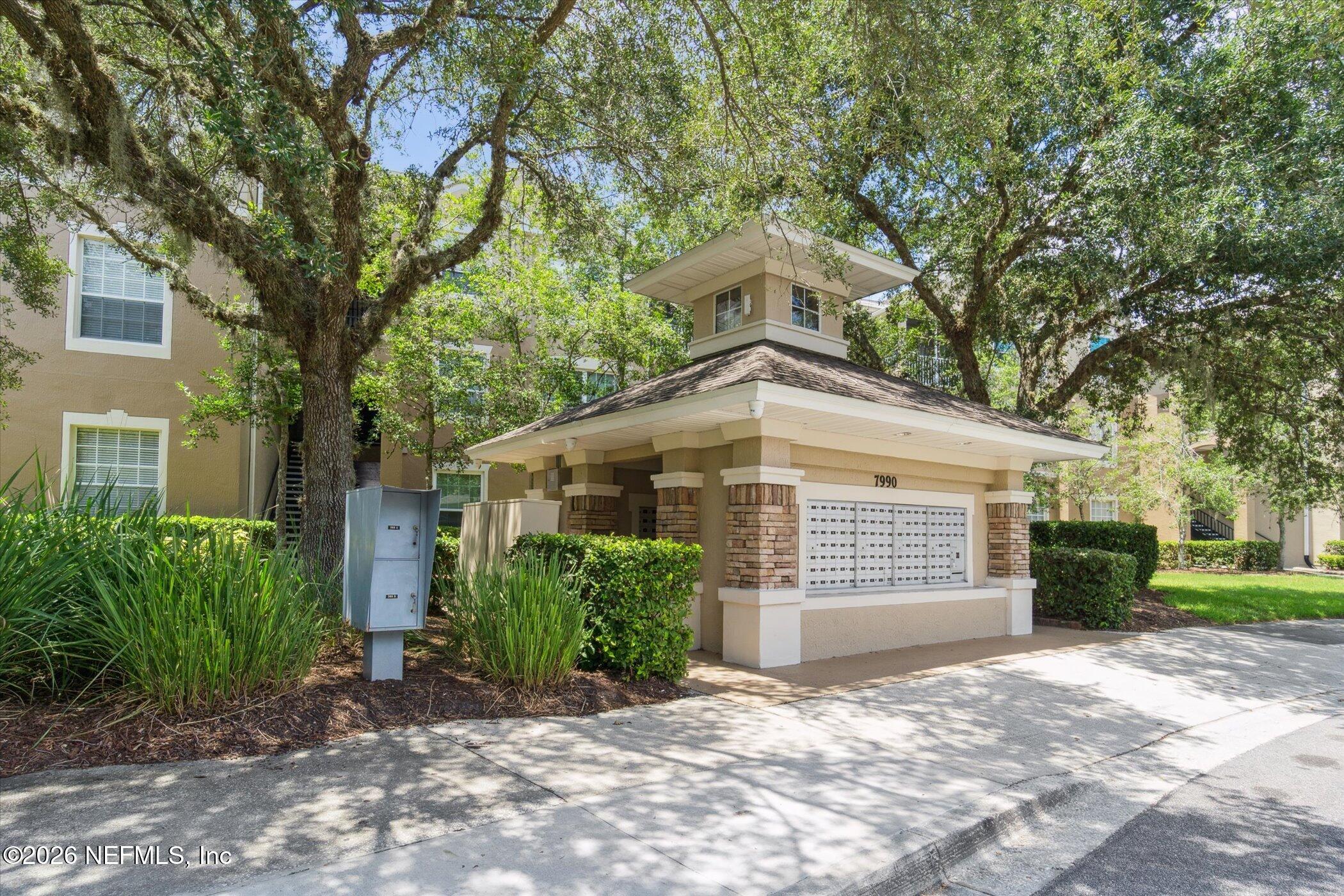 7990 Baymeadows Road, Unit 201 Jacksonville, FL 32256 - Photo 40 of 42 a front view of a house with a yard and garage