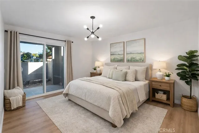 a bedroom with bed and a chandelier