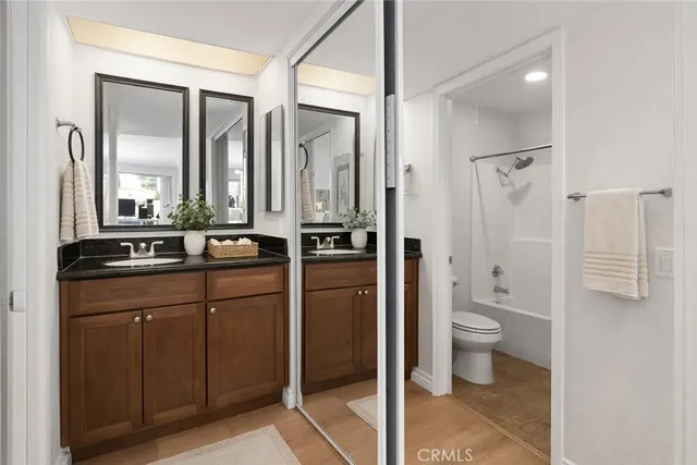 a bathroom with a toilet a sink and a mirror