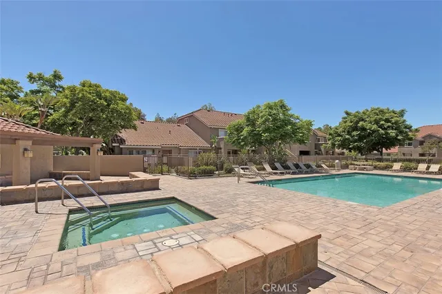 swimming pool view with a seating space
