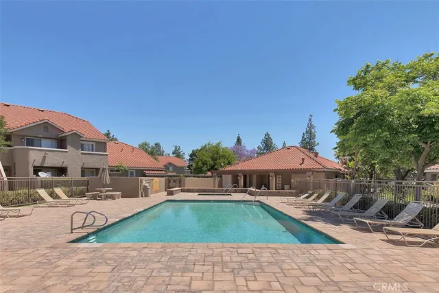 a front view of a house with yard and sitting area