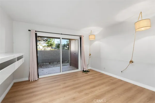 a view of an empty room with glass door