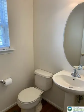a white toilet sitting next to a bathroom sink