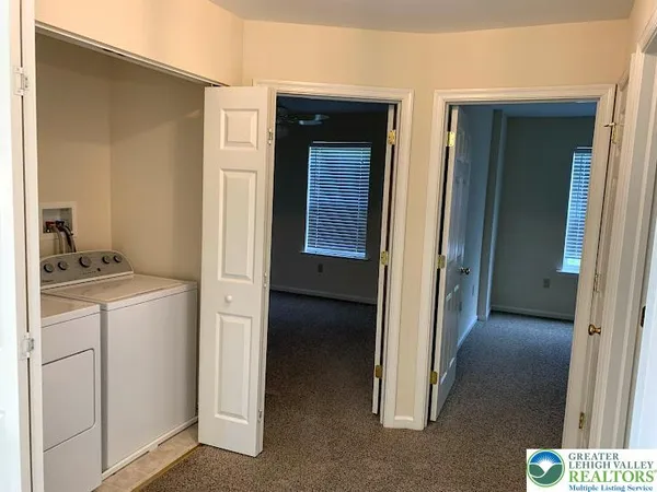 a view of hallway with washer and dryer