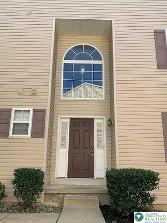 a view of a brick house with large windows