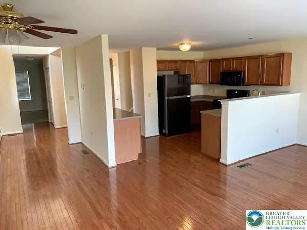 a kitchen with stainless steel appliances granite countertop a refrigerator and a stove top oven