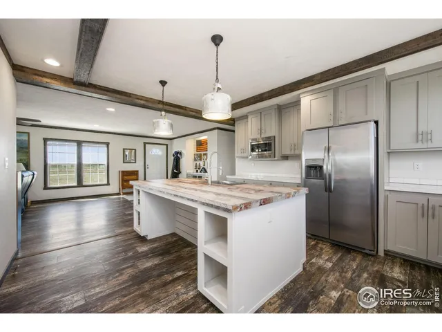 a kitchen with a refrigerator and a sink