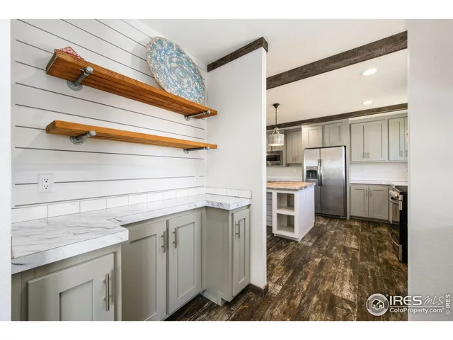 a bedroom with furniture and a large window