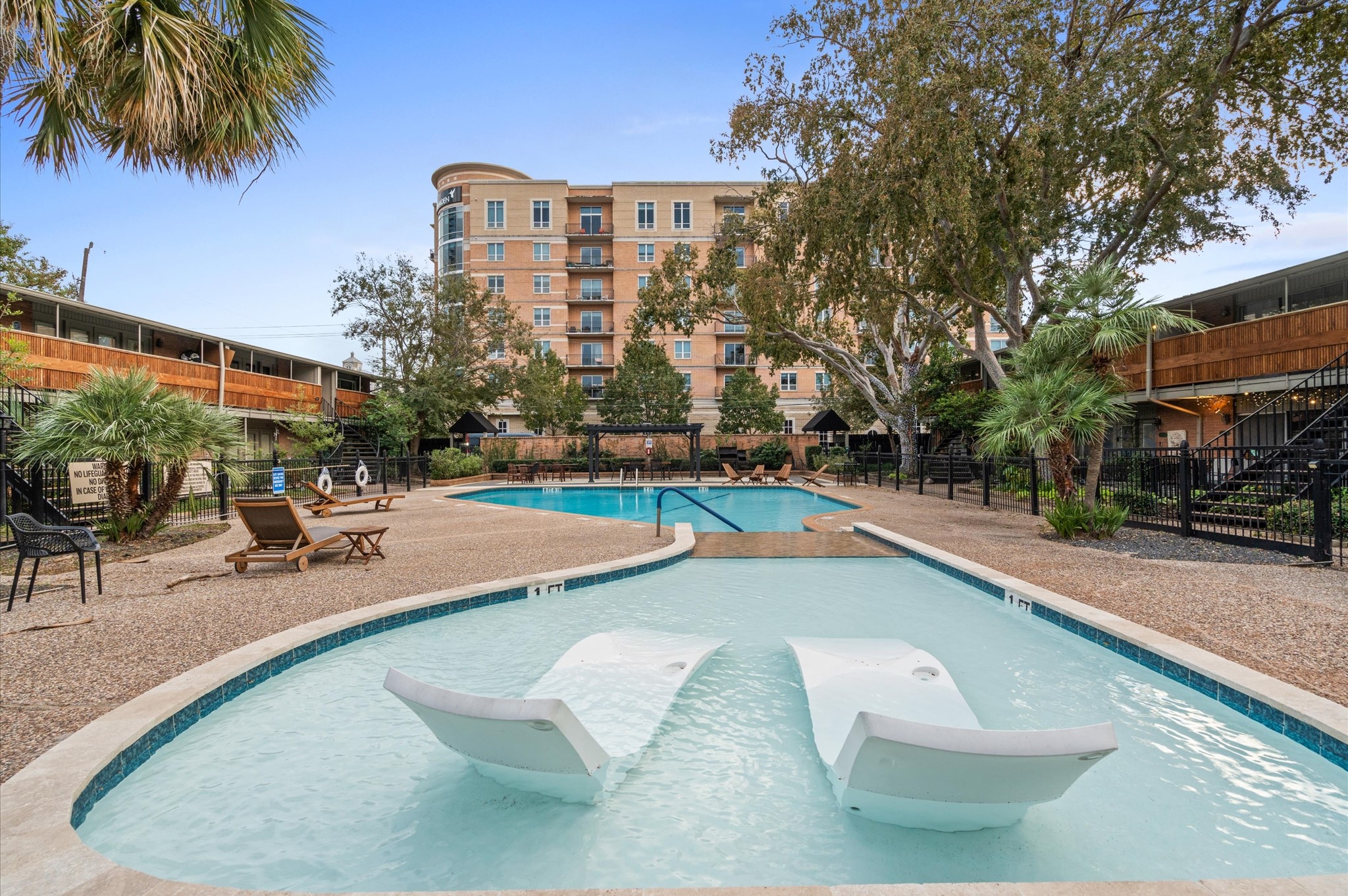 3924 West Alabama Street, Unit 4 Houston, TX 77027 - Photo 18 of 21 A community pool rests inside this well-cared-for gated community.