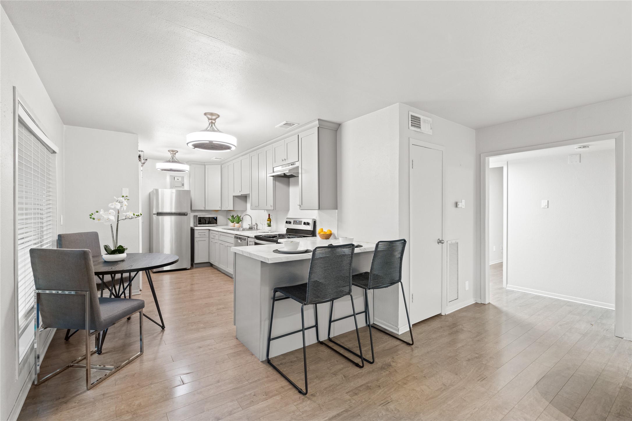 3924 West Alabama Street, Unit 4 Houston, TX 77027 - Photo 2 of 21 The living room and kitchen are joined seamlessly while a convenient breakfast bar separates the spaces.