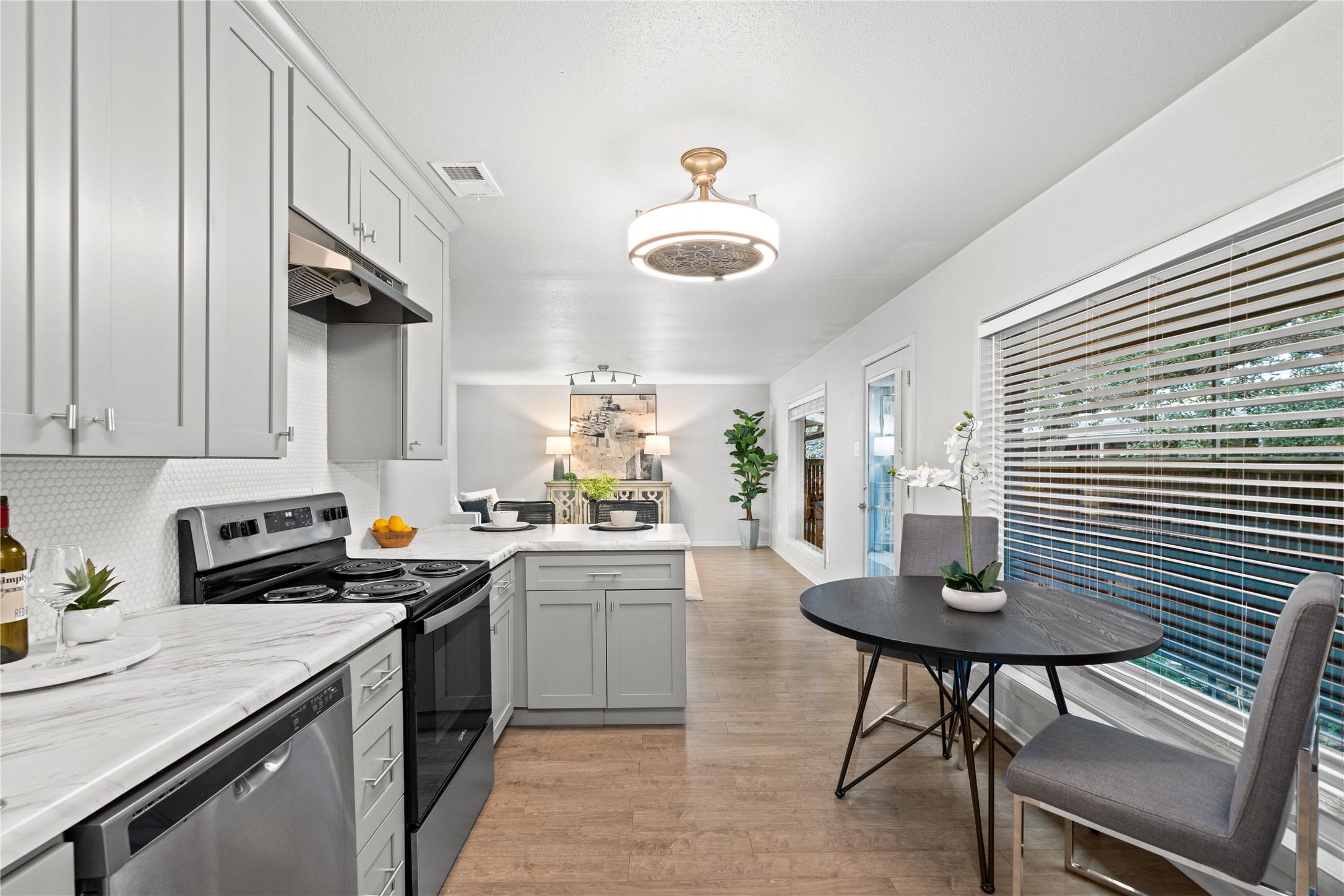 3924 West Alabama Street, Unit 4 Houston, TX 77027 - Photo 3 of 21 Elegant lighting joins abundant natural light to illuminate this well-appointed kitchen.
