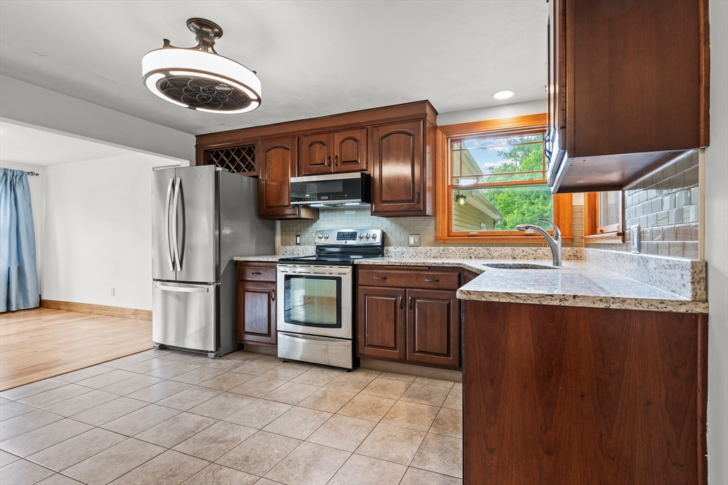 376 Chapin Road Hampden, MA 01036 - Photo 11 of 38 a kitchen with stainless steel appliances granite countertop a sink and a refrigerator