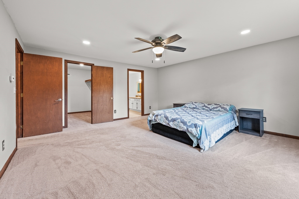 376 Chapin Road Hampden, MA 01036 - Photo 15 of 38 a bedroom with a bed and a chandelier