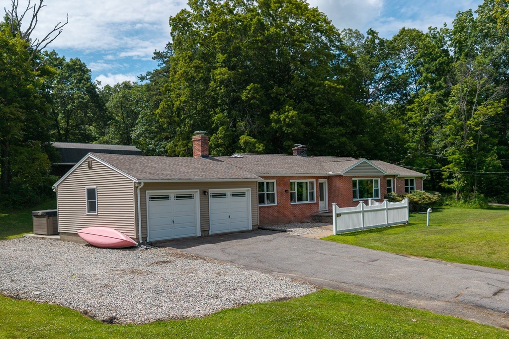376 Chapin Road Hampden, MA 01036 - Photo 2 of 38 a front view of a house with a garden and trees