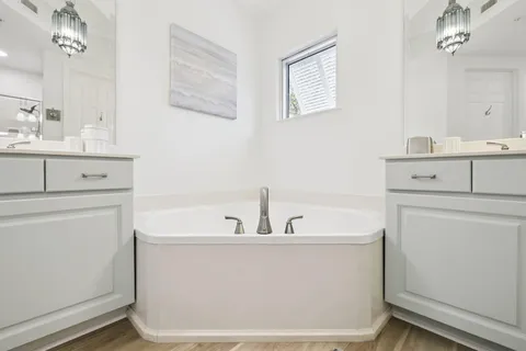 a living room with a flat screen tv and a toilet