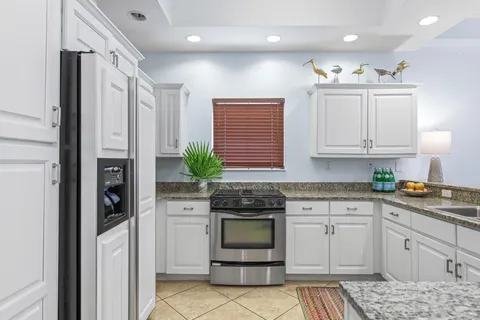 a kitchen with a sink stove and cabinets