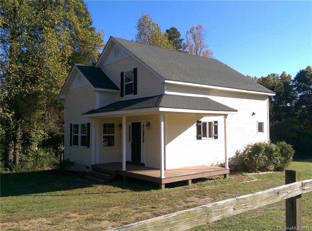 162 Sardis Road Mooresville, NC 28115 - Photo 2 of 15 a view of a white house with a yard and large tree