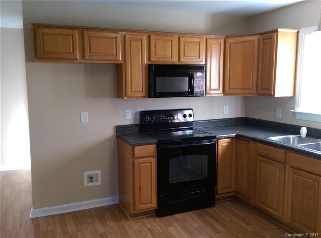 162 Sardis Road Mooresville, NC 28115 - Photo 4 of 15 a kitchen with stainless steel appliances granite countertop a stove a sink and a microwave