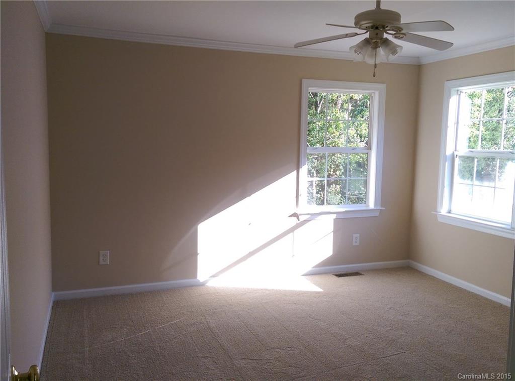 162 Sardis Road Mooresville, NC 28115 - Photo 7 of 15 an empty room with windows and chandelier fan