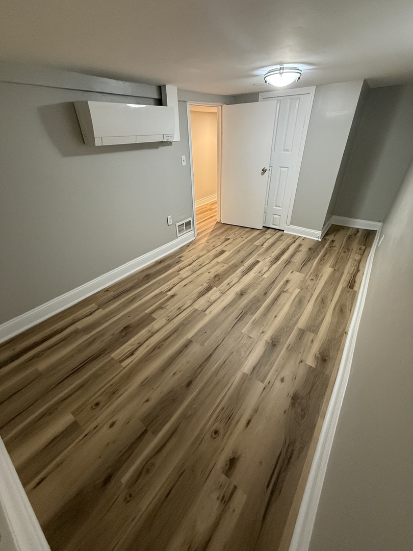 Undisclosed Address Chicago, IL 60647 - Photo 7 of 13 a view of empty room with wooden floor