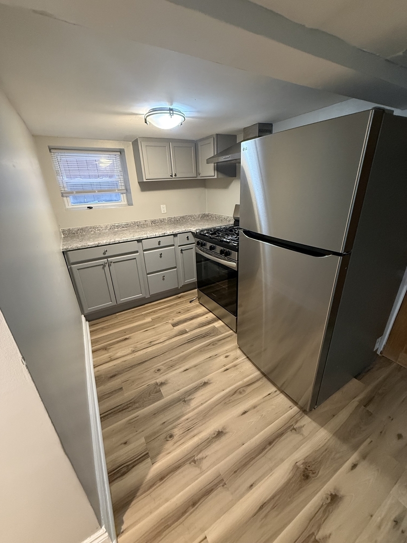 Undisclosed Address Chicago, IL 60647 - Photo 9 of 13 a kitchen with a refrigerator and a stove