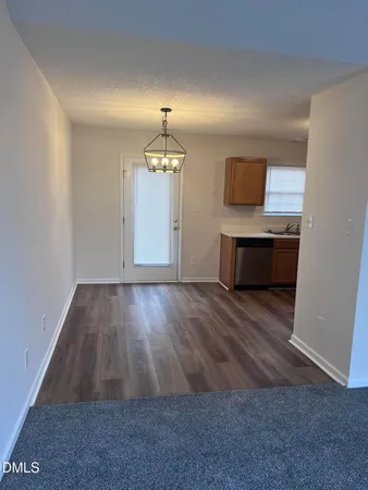 a view of kitchen and wooden floor