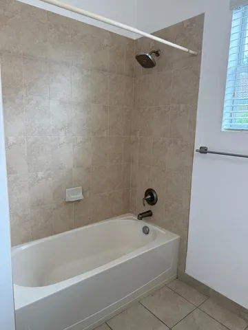 a white bath tub and shower