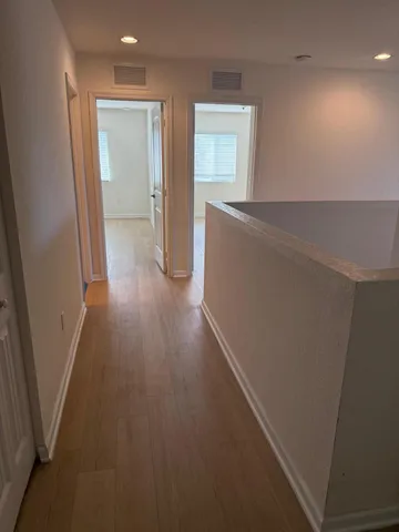a view of hallway with wooden floor