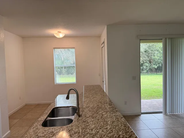 a kitchen with granite countertop a sink and a window