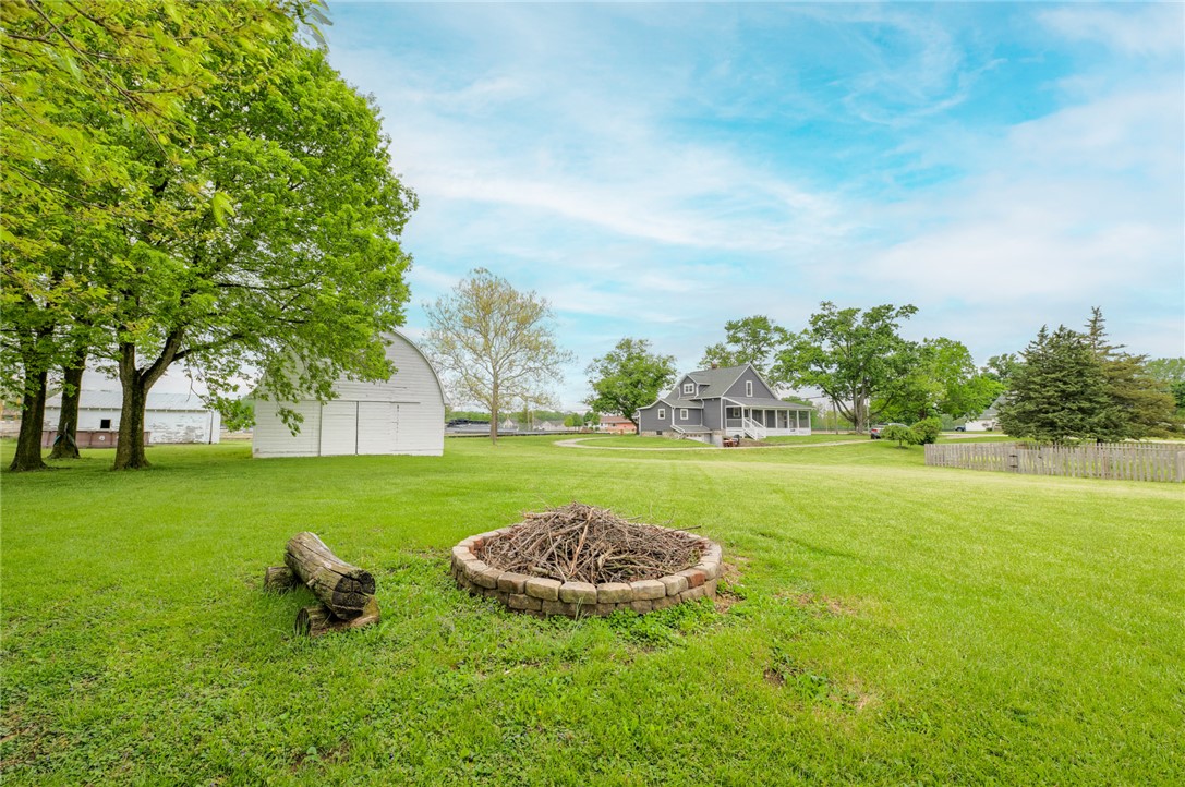 190 Swailes Road Troy, OH 45373 - Photo 77 of 82 This expansive estate features a charming farmhouse, barn, and a fire pit, perfect for outdoor gatherings.