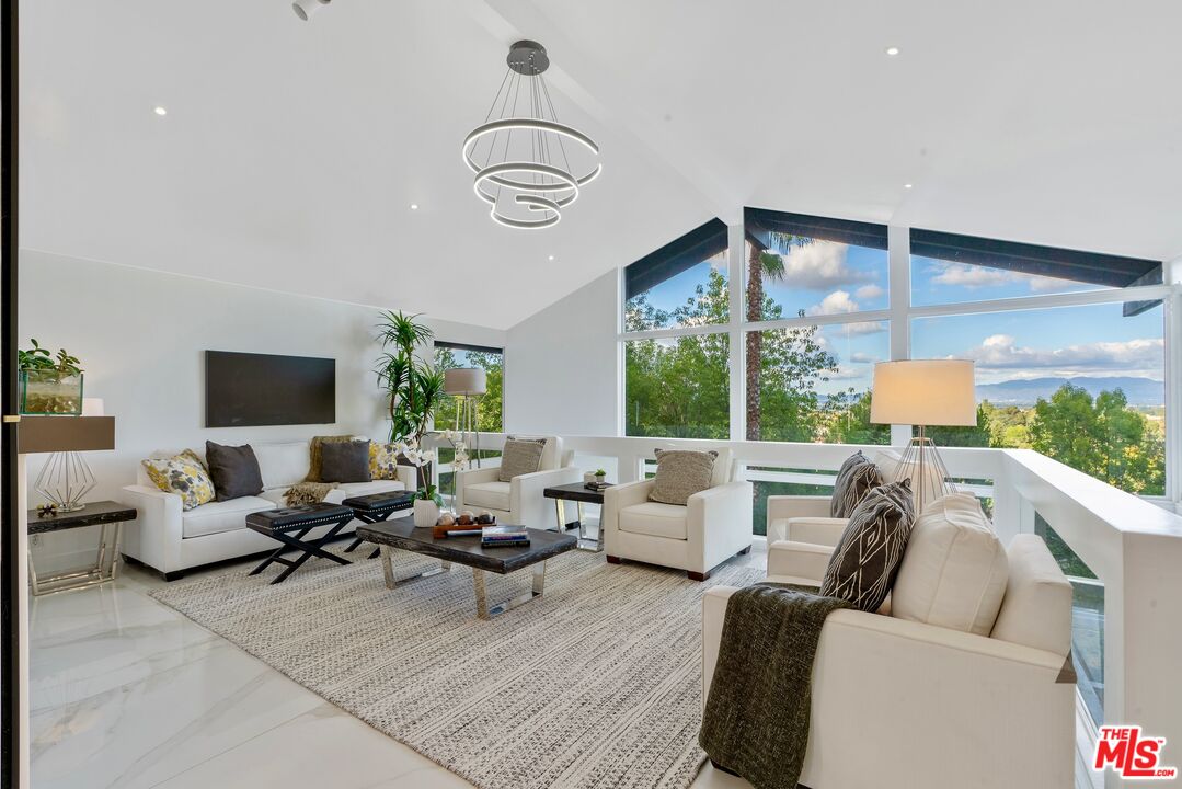 4854 Brewster Drive Tarzana, CA 91356 - Photo 14 of 60 a living room with furniture floor to ceiling window and wooden floor