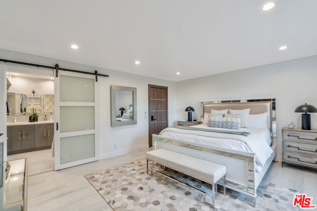 4854 Brewster Drive Tarzana, CA 91356 - Photo 37 of 60 a bedroom with a bed and a refrigerator